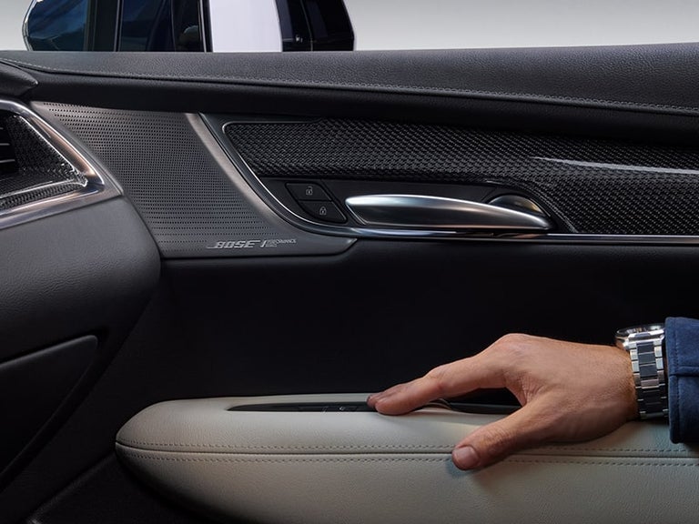 A Man Adjusts the Air Temperature Using the Cadillac's XT5 Driver Climate Control