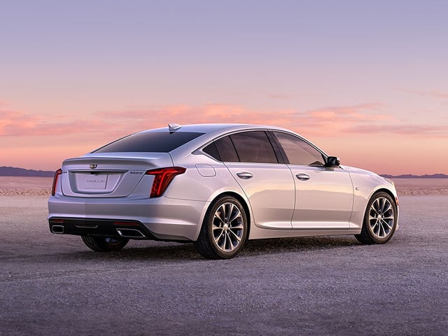 2023 Summit White Cadillac CT5 Fiercely Driving During a Golden Sunset